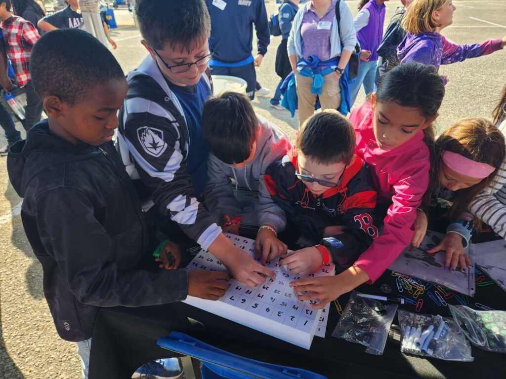 Students learning about magnetic fields at the VST Exhibit