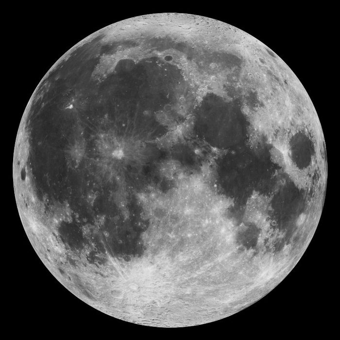 The near side of the moon, its face marked with large smooth dark plains among the craters